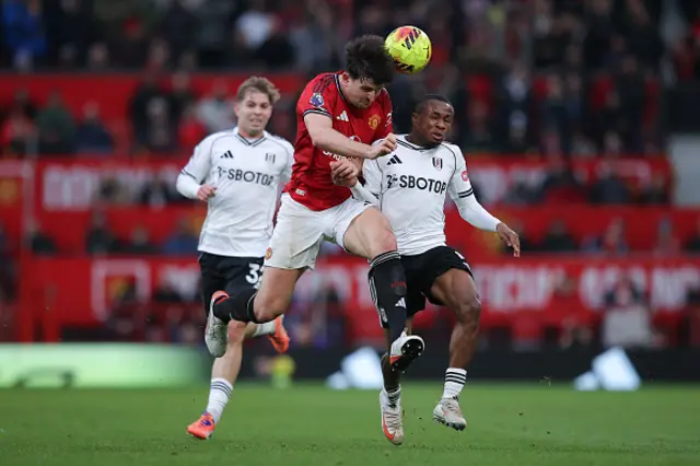 Harry Maguire of Manchester United battles for possession with Samuel Chukwueze