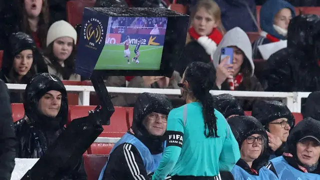 The referee looks at the VAR monitor
