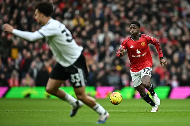 Kobbie Mainoo (R) dribbles the ball