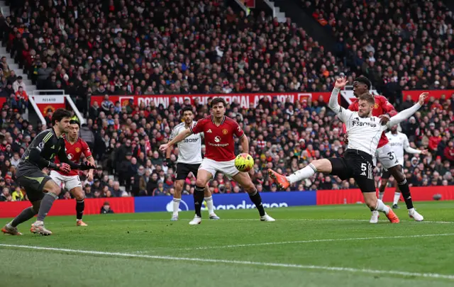 Joachim Andersen of Fulham has his shot saved by Senne Lammens