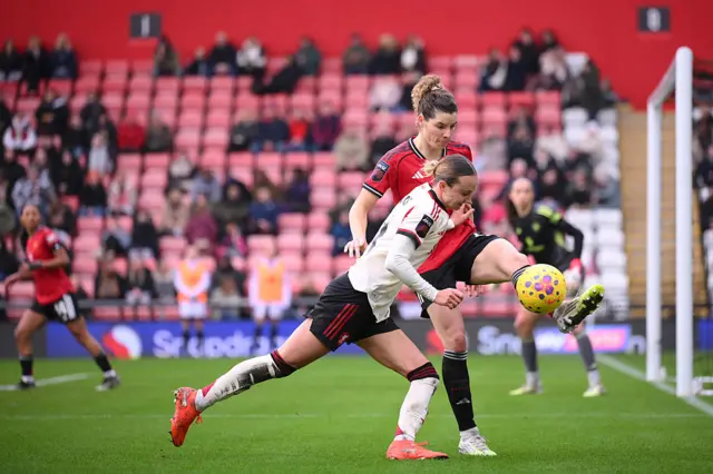 Dominique Janssen of Manchester United battles for possession with Martha Thomas of Liverpool