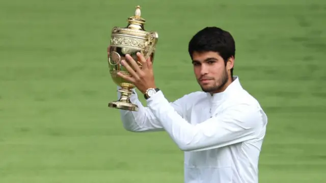 Carlos Alcaraz holds the Wimbledon trophy