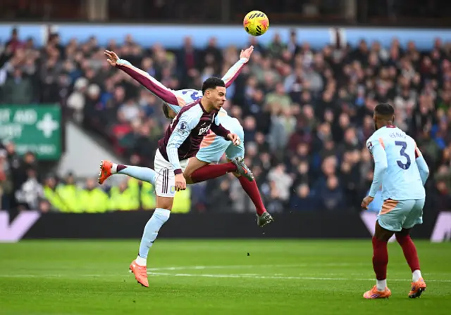 Morgan Rogers of Aston Villa contends for the aerial ball with Kristoffer Ajer