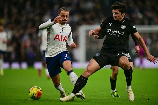 bdukodir Khusanov (R) challenges Tottenham Hotspur's Dutch midfielder Xavi Simons