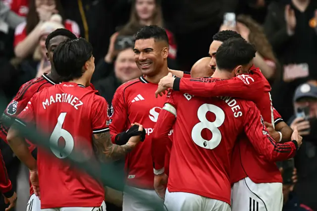 Casemiro (C) celebrates with teammates
