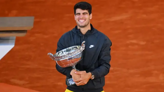 Carlos Alcaraz holds the French Open trophy