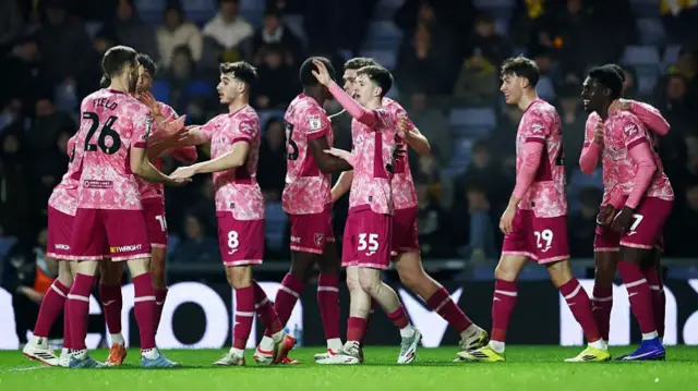 Norwich players celebrate at Oxford