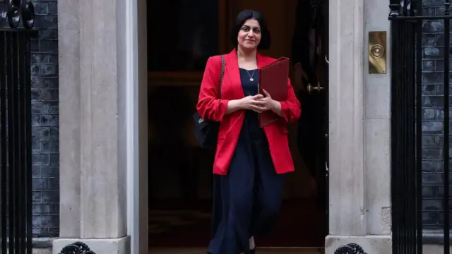 Shabana Mahmood walks out of 10 Downing Street in a pink jacket and holding a red folder