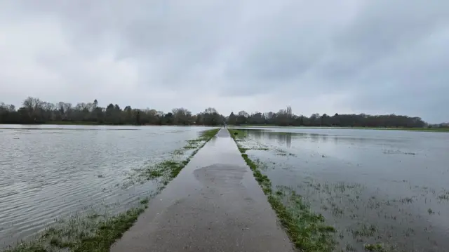 A flooded field with a path running through the middle in Cambridgeshire