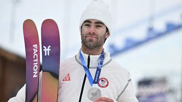 Alex Hall picturing with a silver medal
