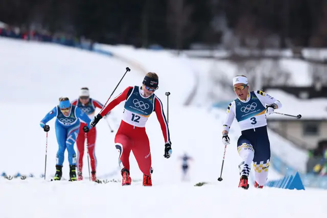 Milla Grosberghaugen Andreassen of Team Norway crosses the finish line ahead of Johanna Hagstroem of Team Sweden