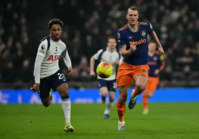 Tottenham Hotspur's French midfielder #28 Wilson Odobert (L) and Newcastle United's English defender #33 Dan Burn chase after the ball during the English Premier League football match between Tottenham Hotspur and Newcastle United at the Tottenham Hotspur Stadium in London, on February 10, 2026.