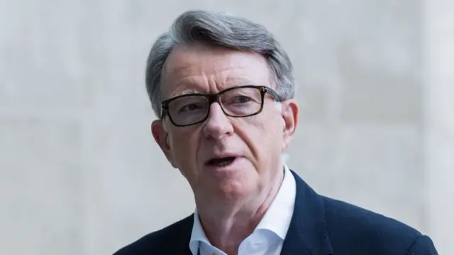Mandelson speaking outside of a London building.