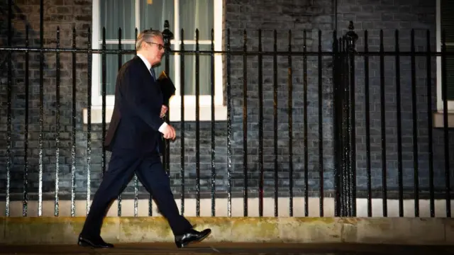 Keir Starmer walks in front of Downing Street
