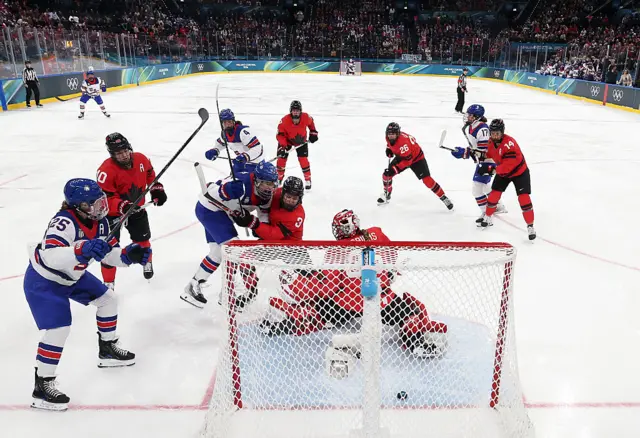 USA score against Canada in the women's ice hockey preliminary match at the Winter Olympics