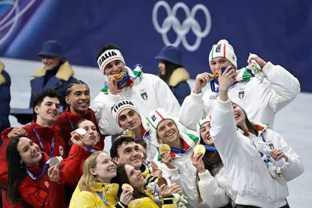 Team Italy, Team Canada and Team Belgium pose for a selfie on the podium
