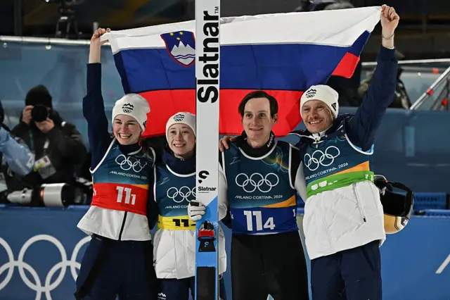 Slovenia celebrate winning the mixed team ski jumping