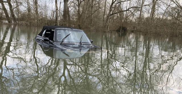 A Mini car submerged in flood water