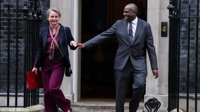 Yvette Cooper and David Lammy smile and hold hands as they had their separate ways as they step out No 10