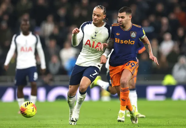 Xavi Simons of Tottenham Hotspur and Bruno Guimaraes of Newcastle United battle for possession during the Premier League match between Tottenham Hotspur and Newcastle United at Tottenham Hotspur Stadium on February 10, 2026 in London, England.