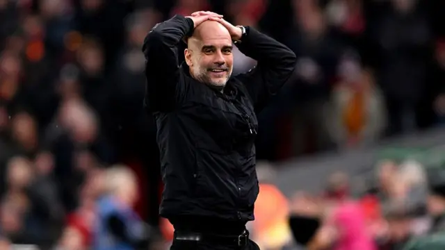 Pep Guardiola with his hands on his head