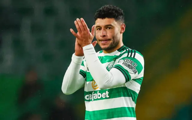 Alex Oxlade-Chamberlain applauds the fans at Celtic Park