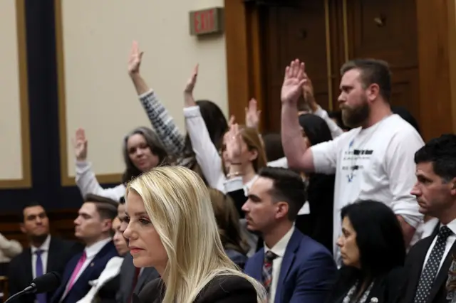 Survivors of convicted sex-offender Jeffrey Epstein stand in the audience as U.S. Attorney General Pam Bondi testifies before the House Judiciary Committee
