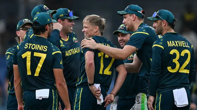 Australia's Nathan Ellis (C) celebrates with teammates after taking the wicket of Ireland's Curtis Campher