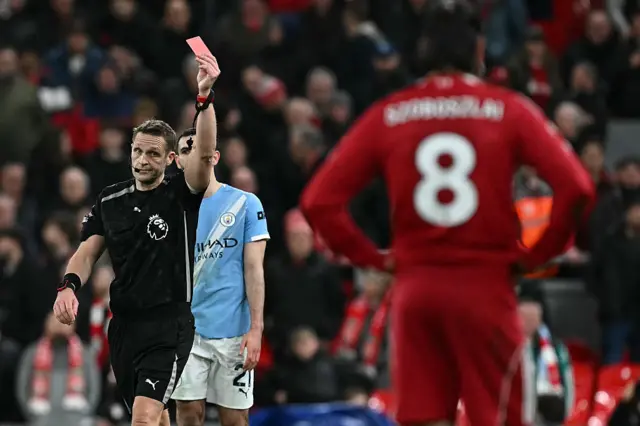 Craig Pawson showing Dominik Szoboszlai a red card