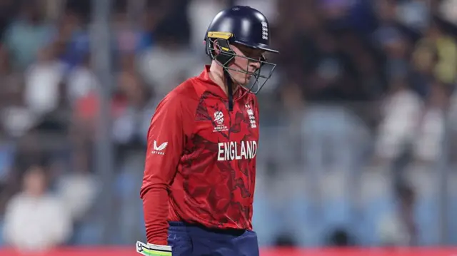 Tom Banton of England looks dejected as he leaves the field after being caught out by Brandon King