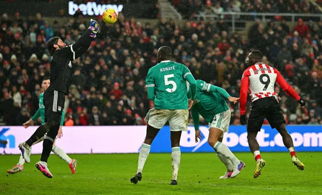 Alisson Becker saves a shot