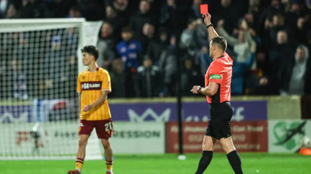 Referee Steven McLean shows Motherwell's Lukas Fadinger a red card after a VAR check