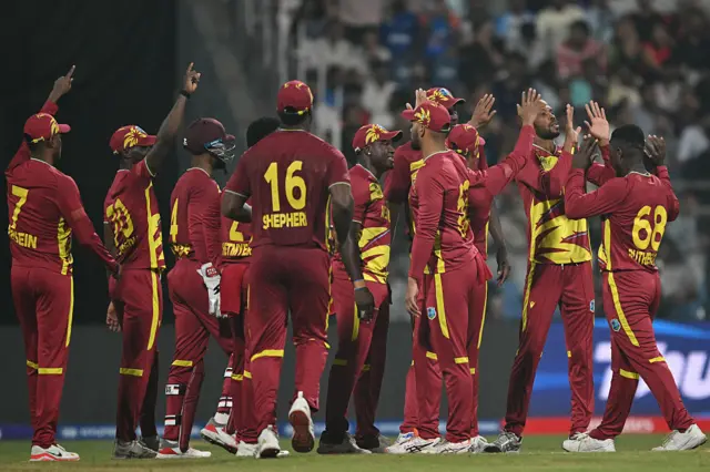 West Indies' players celebrate after the dismissal of England's Jos Buttler during the 2026 ICC Men's T20 Cricket World Cup group stage match