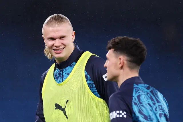 Erling Haaland smiles at teammate Phil Foden
