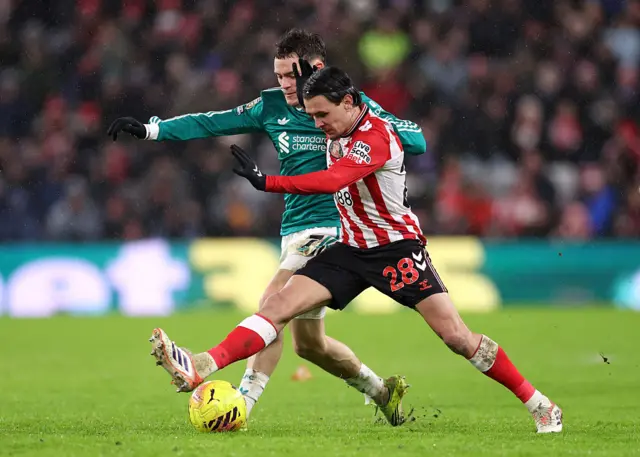Enzo Le Fee is challenged by Florian Wirtz