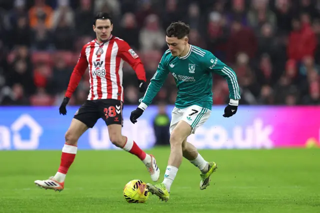 Florian Wirtz on the ball whilst under pressure from Enzo Le Fee