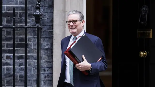 Prime Minister Keir Starmer leaves Downing Street holding two folders