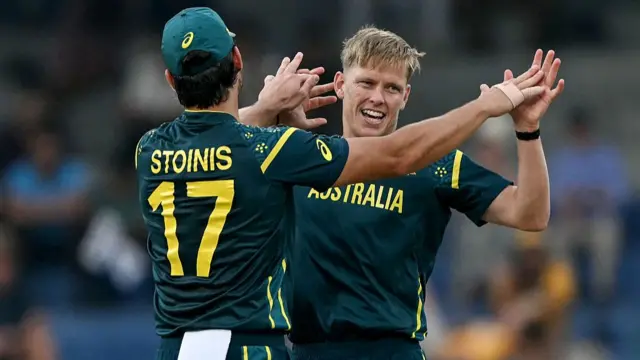 Australia's Nathan Ellis (R) celebrates with teammate Marcus Stoinis after taking the wicket of Ireland's Curtis Campher