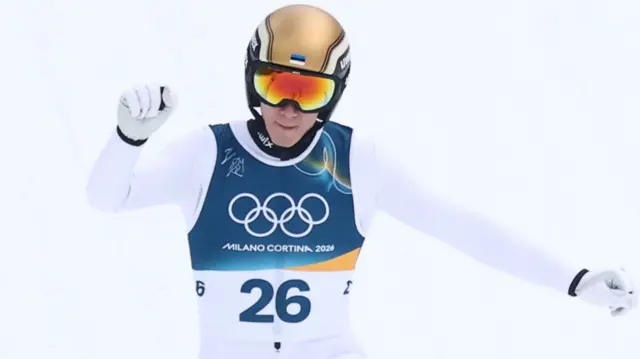 Kristjan Ilves celebrates his ski jump