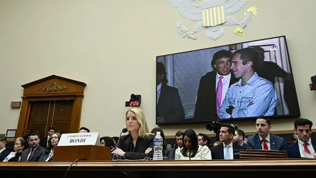 An image of US President Donald Trump and deceased financier Jeffrey Epstein is displayed behind Pam Bondi, US attorney general, during a House Judiciary Committee hearing in Washington, DC, US, on Wednesday, Feb. 11, 2026.