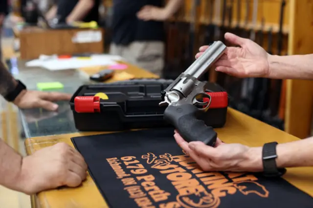 A person at a gun store showing a customer a Ruger GP100 Magnum 357 on June 3, 2022 in Ottawa, Canada.