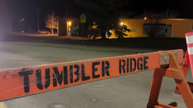 A makeshift road-stopper which says 'Tumbler Ridge'