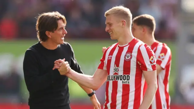 Thomas Frank celebrates with Ben Mee