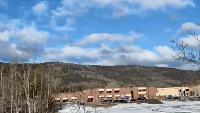 Vehicles are parked outside the Tumbler Ridge Secondary School, the site of a deadly mass shooting in Tumbler Ridge.