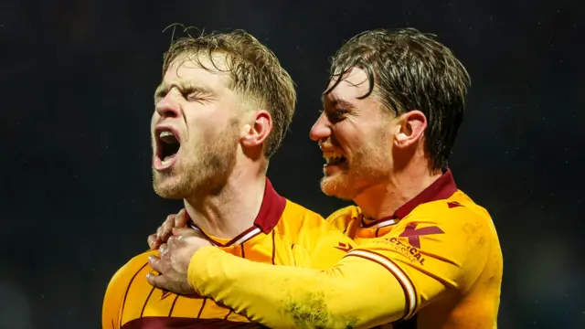 Motherwell's Stephen Welsh (L) celebrates scoring to make it 1-1 with Callum Slattery