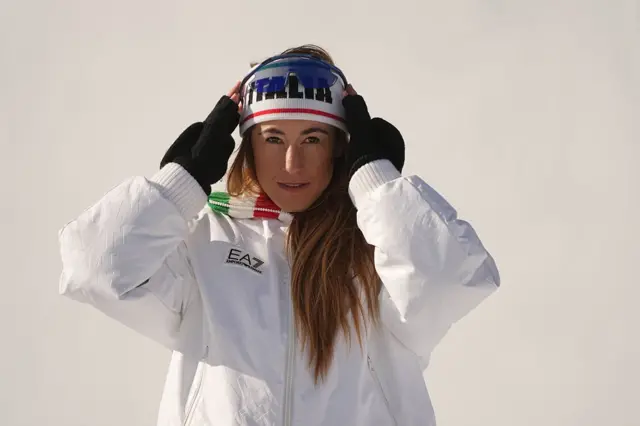 Sofia Goggia adjusts her headband on the medal podium