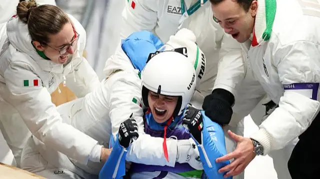 Italy celebrate winning the women's doubles in the luge