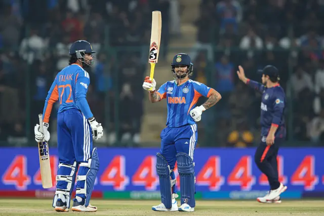 Ishan Kishan of India raises his bat after scoring a half-century