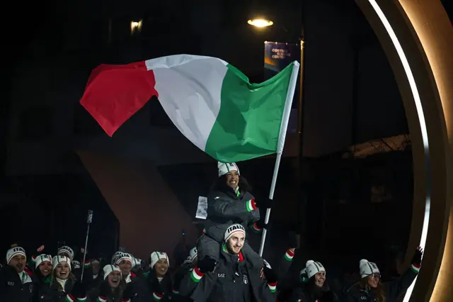 Federica Brignone on the shoulders of team-mate Amos Mosaner during the Olympic opening ceremony