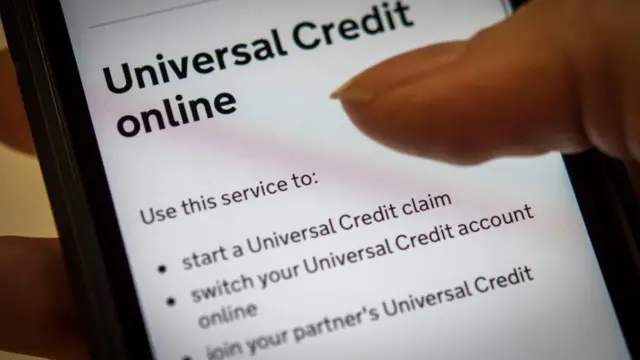 A person using the Universal Credit online portal on a smartphone